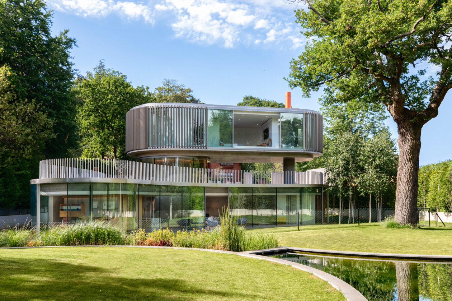 Modern white house exterior on green lawn — Greenways, designed by Eldridge Architects, London