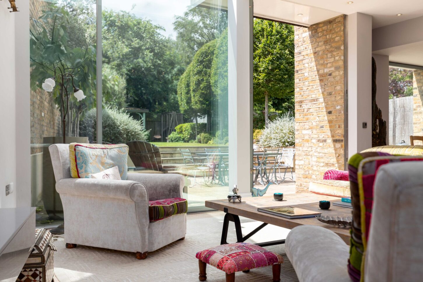 Bright living room with white sofas and garden view — Chisholm Road, London