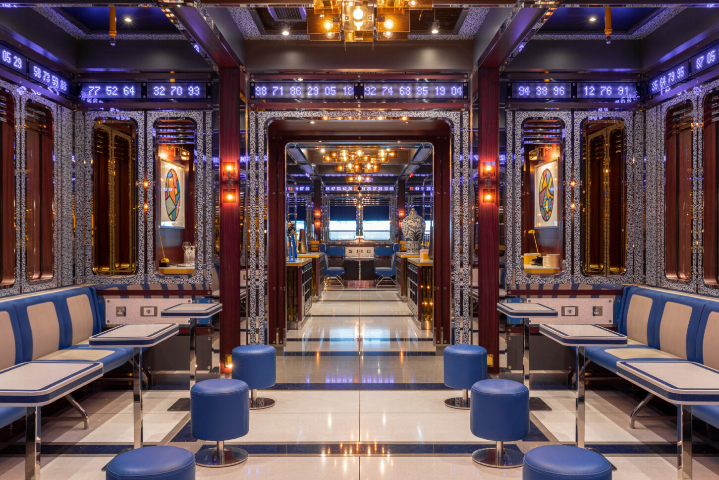 Booth seating with digital ticker displays and mirrored corridor — Bob Bob Ricard City, restaurant photographer London