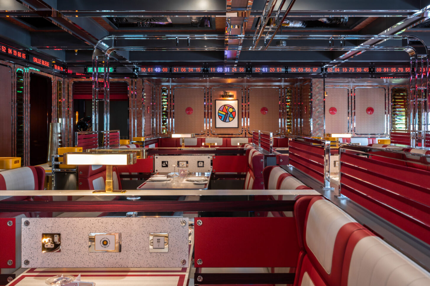Booth dining room with digital ticker displays and art panel — restaurant photographer London, Bob Bob Ricard City