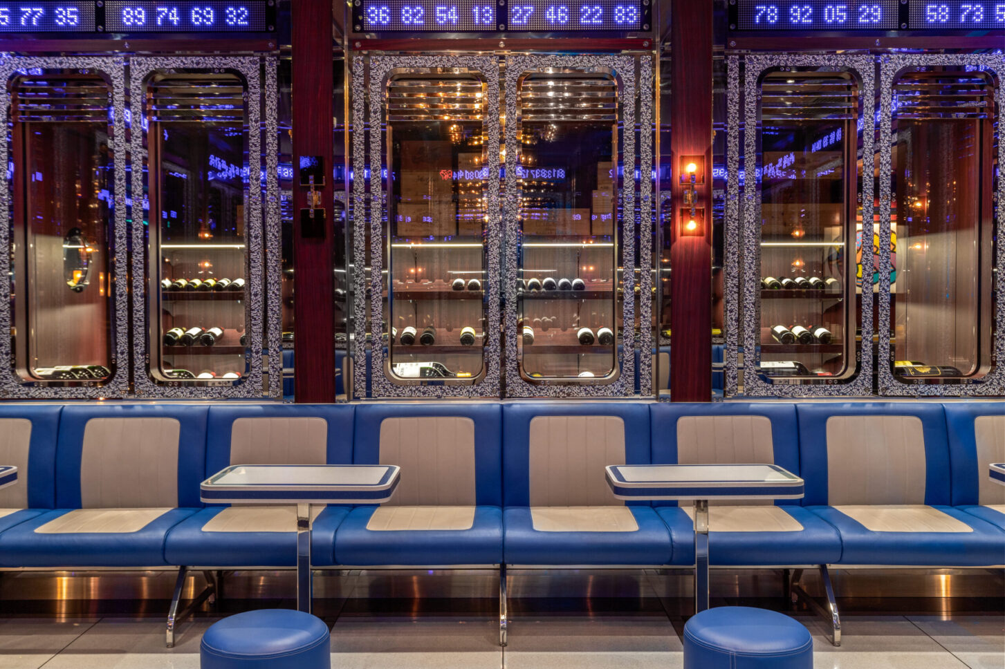Illuminated wine display wall with booth seating — Bob Bob Ricard City, restaurant photographer London