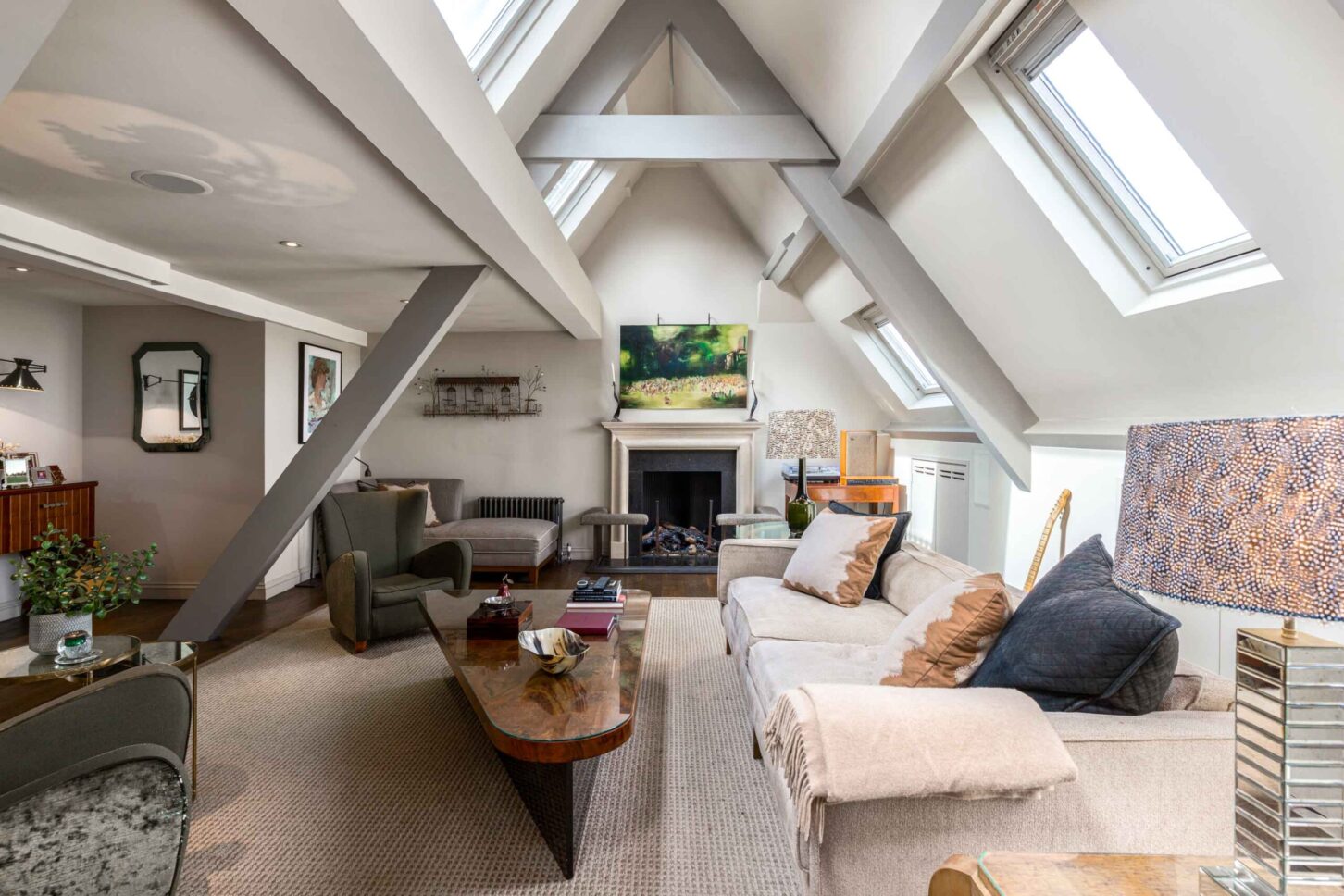 Attic living room with sloped wood-beam ceiling — Amies Street Penthouse, London