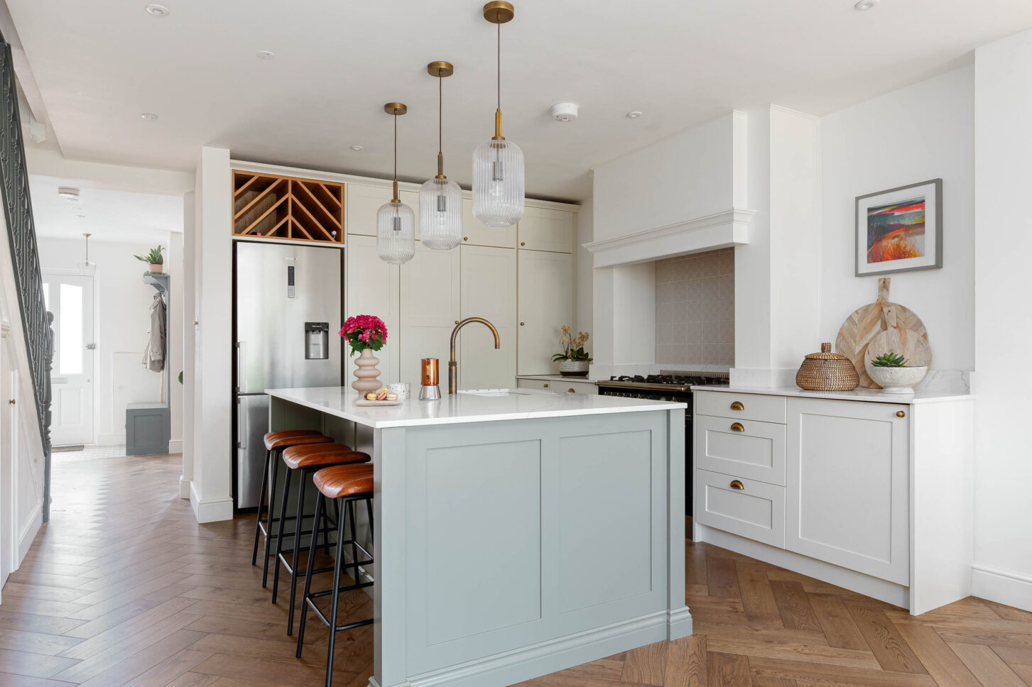 Open-plan kitchen with sage green island — interior photographer London, Blue + Green Interiors