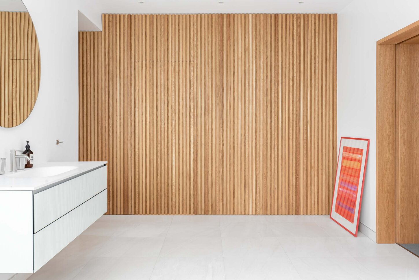 Bathroom with fluted timber wall panelling and floating vanity — interior photographer London, Hoban Design Wimbledon