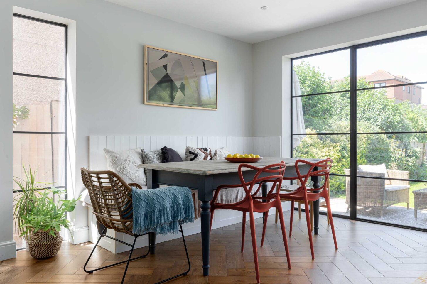 Dining nook with banquette seating and garden views — interior photographer London, Blue + Green Interiors