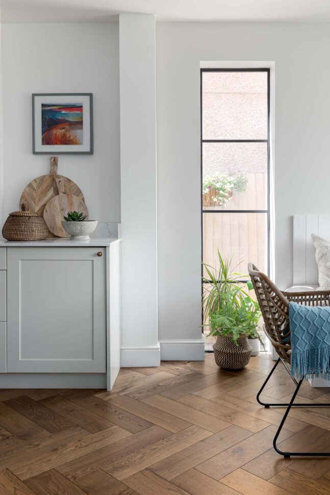 Sage green cabinetry beside window seating area — interior photographer London, Blue + Green Interiors