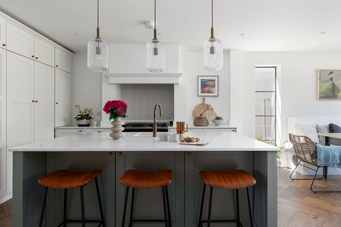 Kitchen island with leather stools opening onto lounge area — interior photographer London, Blue + Green Interiors