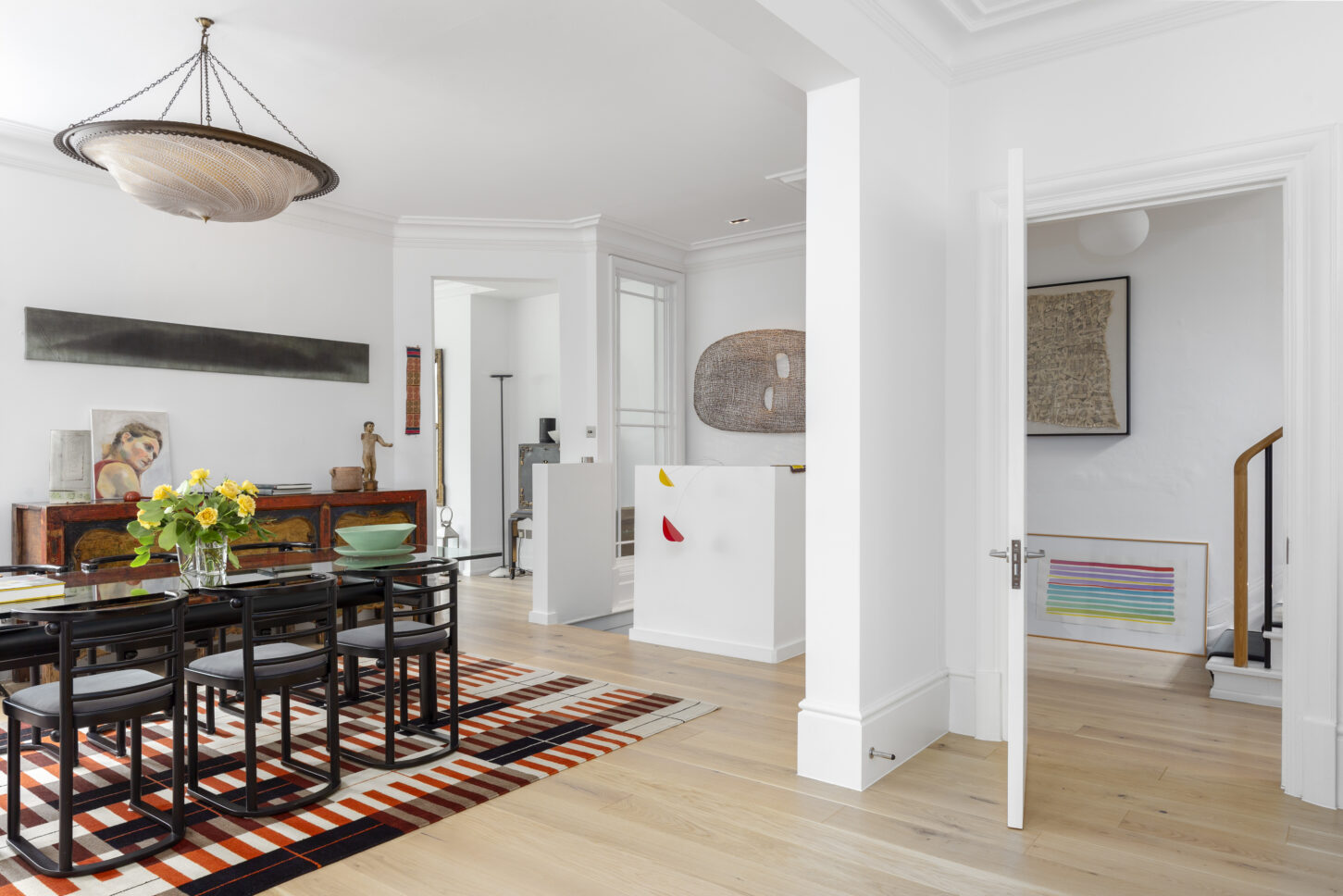 Open-plan dining and living space with art collection — interior photographer London, Hoban Design Wimbledon