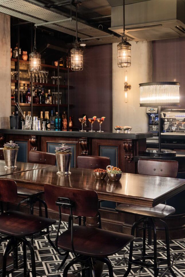 Communal bar table with patterned tiled floor — private members' restaurant, restaurant photographer London