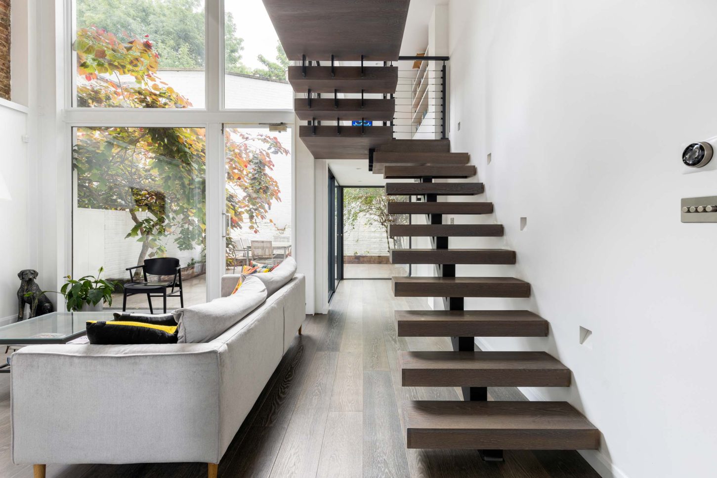 Floating staircase with living room and garden view — Canonbury, designed by Unknown Makers, London