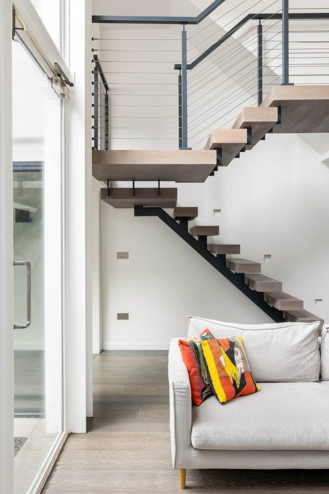 Floating oak staircase with black steel frame and cable railing — Canonbury, designed by Unknown Makers, London
