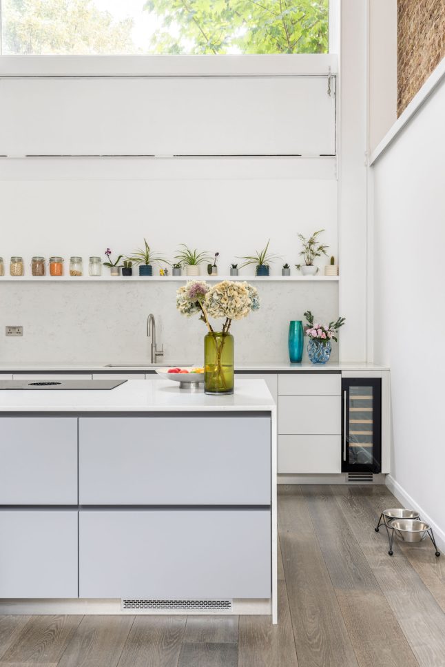 Kitchen counter with white cabinetry, sink, and open shelving — Canonbury, designed by Unknown Makers, London