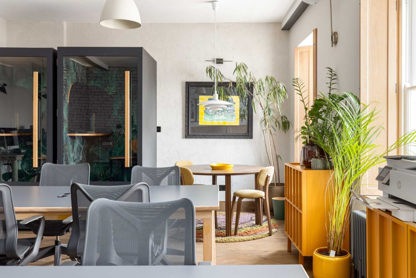 Office phone booths and open desks with breakout seating area, designed by Unknown Makers — Kingsland project, London