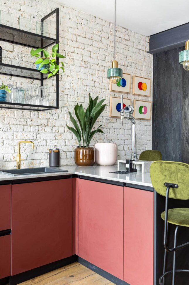 Office pantry counter with coral cabinetry and exposed brick wall, designed by Unknown Makers — Kingsland project, London