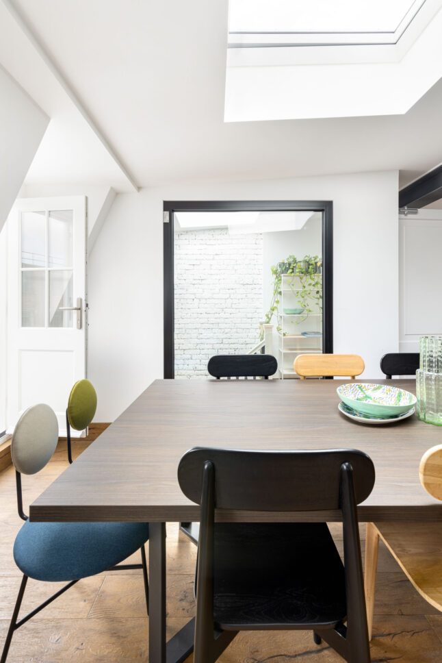 Office dining area under skylight with view to brick courtyard, designed by Unknown Makers — Kingsland project, London